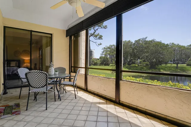 a view of a chairs and table in balcony