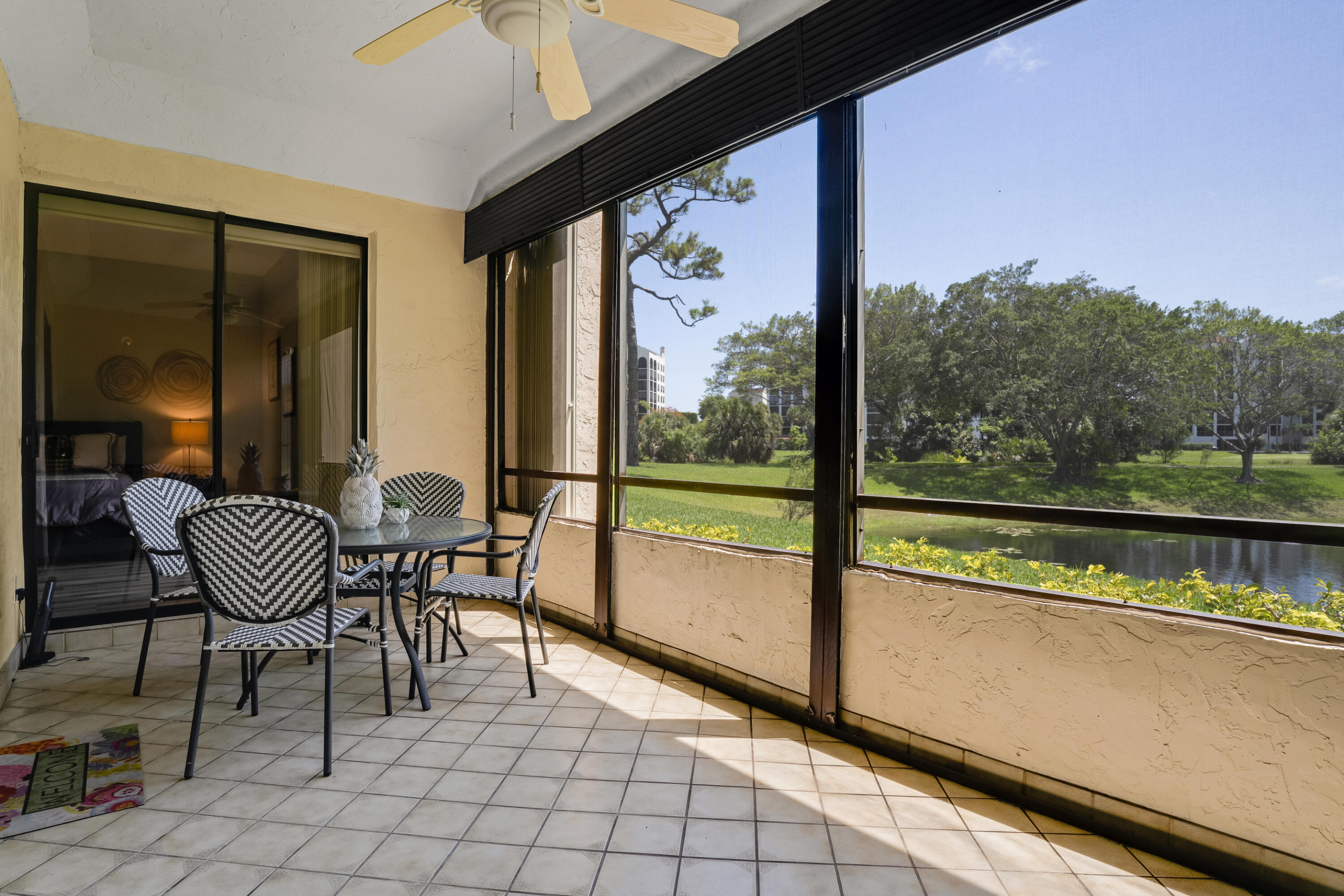 7472 La Paz Boulevard, Unit 102 Boca Raton, FL 33433 - Photo 3 of 14 a view of a chairs and table in balcony