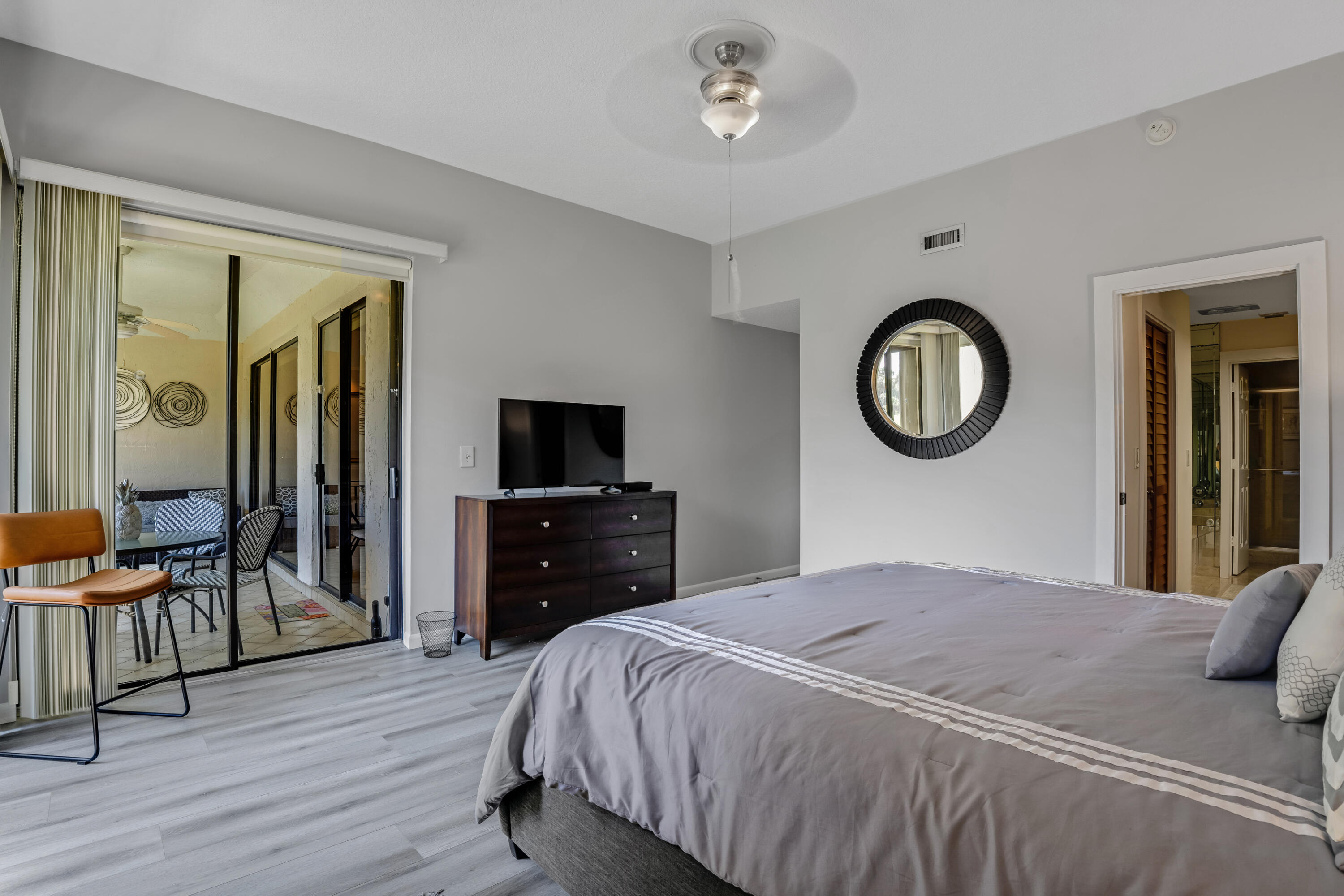 7472 La Paz Boulevard, Unit 102 Boca Raton, FL 33433 - Photo 7 of 14 a bedroom with a bed and a television