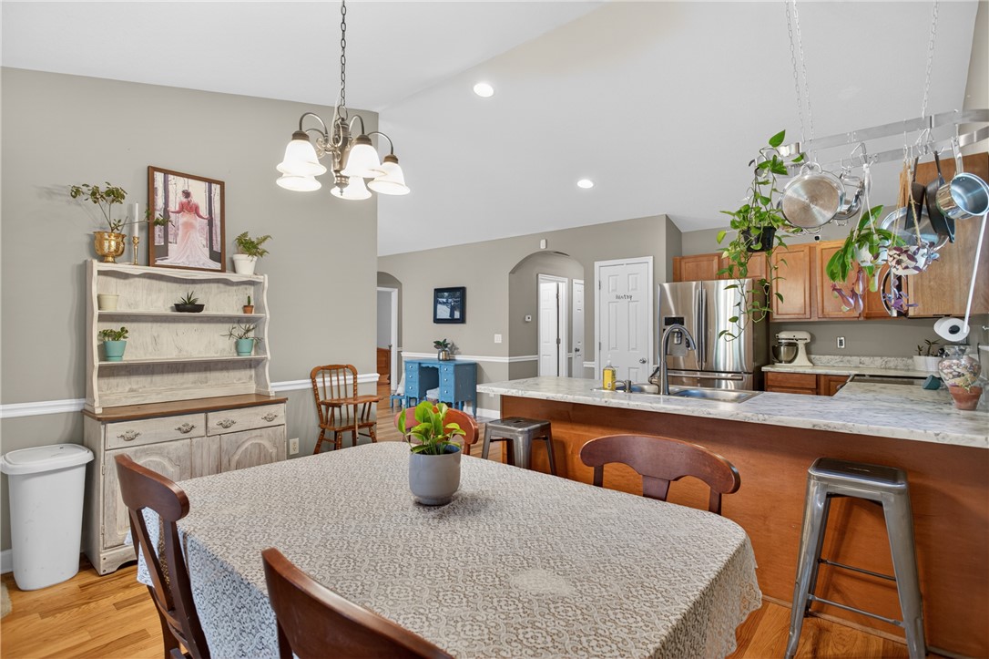 151 Towne Creek Trail Anderson, SC 29621 - Photo 14 of 49 An inviting open-plan living area features warm wood flooring and ample space for dining and cooking.