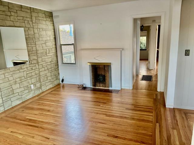 1606 Stannage Avenue Berkeley, CA 94702 - Photo 14 of 16 a view of empty room with wooden floor and fireplace
