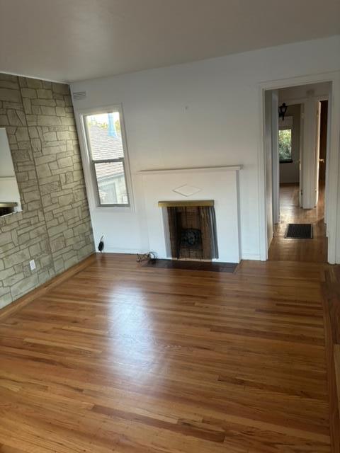 1606 Stannage Avenue Berkeley, CA 94702 - Photo 16 of 16 an empty room with wooden floor and a fireplace