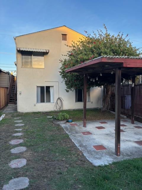 1606 Stannage Avenue Berkeley, CA 94702 - Photo 3 of 16 a view of a house with backyard and a garden