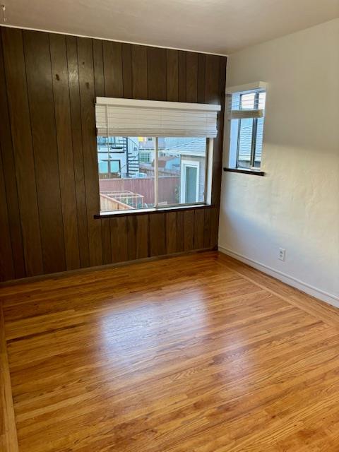 1606 Stannage Avenue Berkeley, CA 94702 - Photo 5 of 16 an empty room with wooden floor and windows