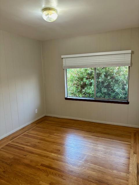 1606 Stannage Avenue Berkeley, CA 94702 - Photo 6 of 16 a view of an empty room with wooden floor and a window