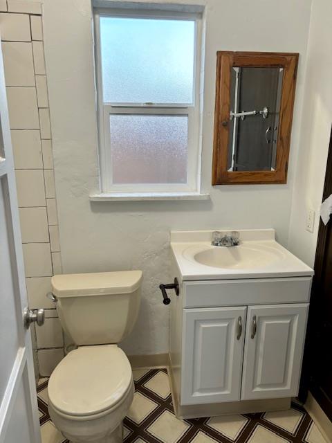 1606 Stannage Avenue Berkeley, CA 94702 - Photo 9 of 16 a bathroom with a toilet a sink and mirror