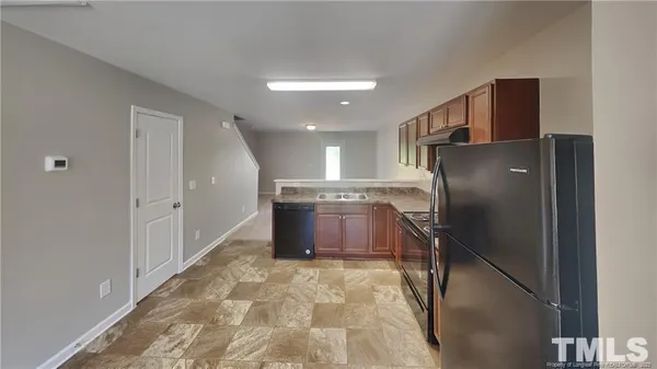 a kitchen with stainless steel appliances granite countertop a refrigerator and a sink