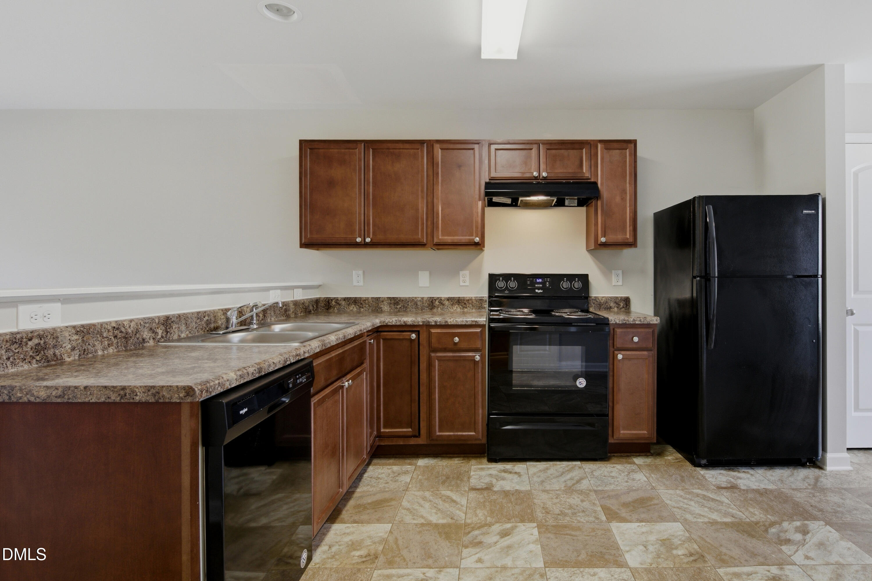 508 Directive Drive Hope Mills, NC 28348 - Photo 5 of 17 a kitchen with a refrigerator and a stove