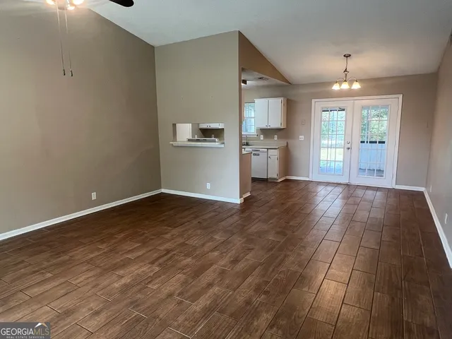 a view of a kitchen with wooden floor and a kitchen