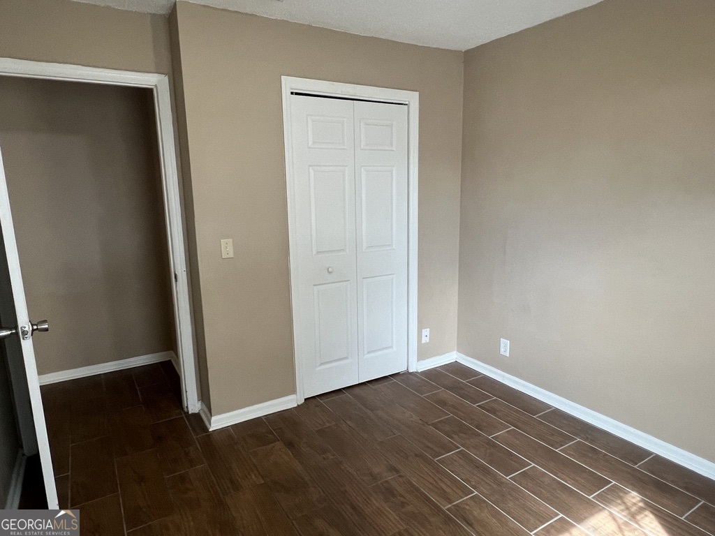 412 Fairfield Court St. Marys, GA 31558 - Photo 8 of 10 an empty room with wooden floor and closet