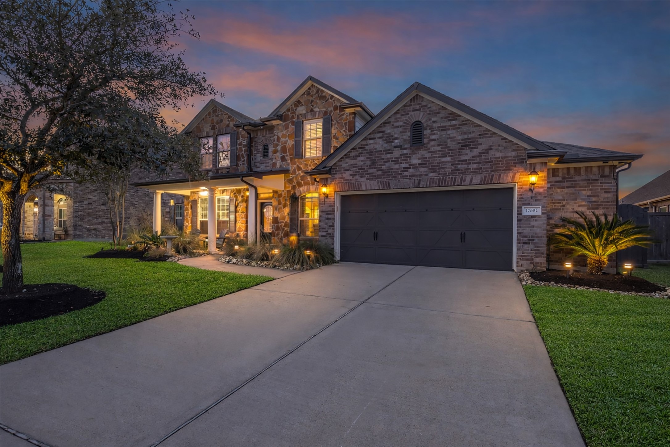 a front view of a house with a yard and garage