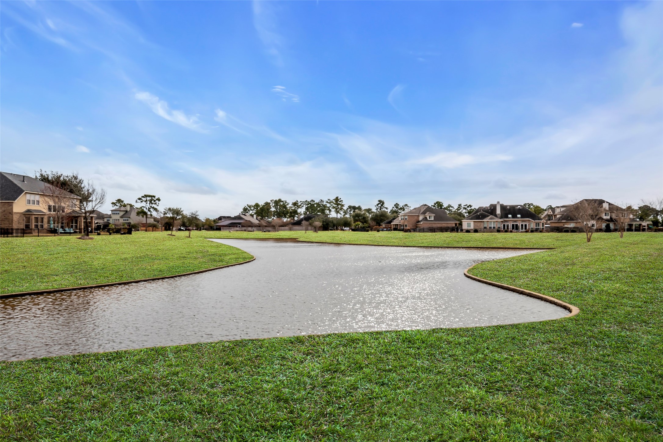 12602 Spellbrook Point Lane Tomball, TX 77377 - Photo 15 of 47 a view of a lake with houses in the back