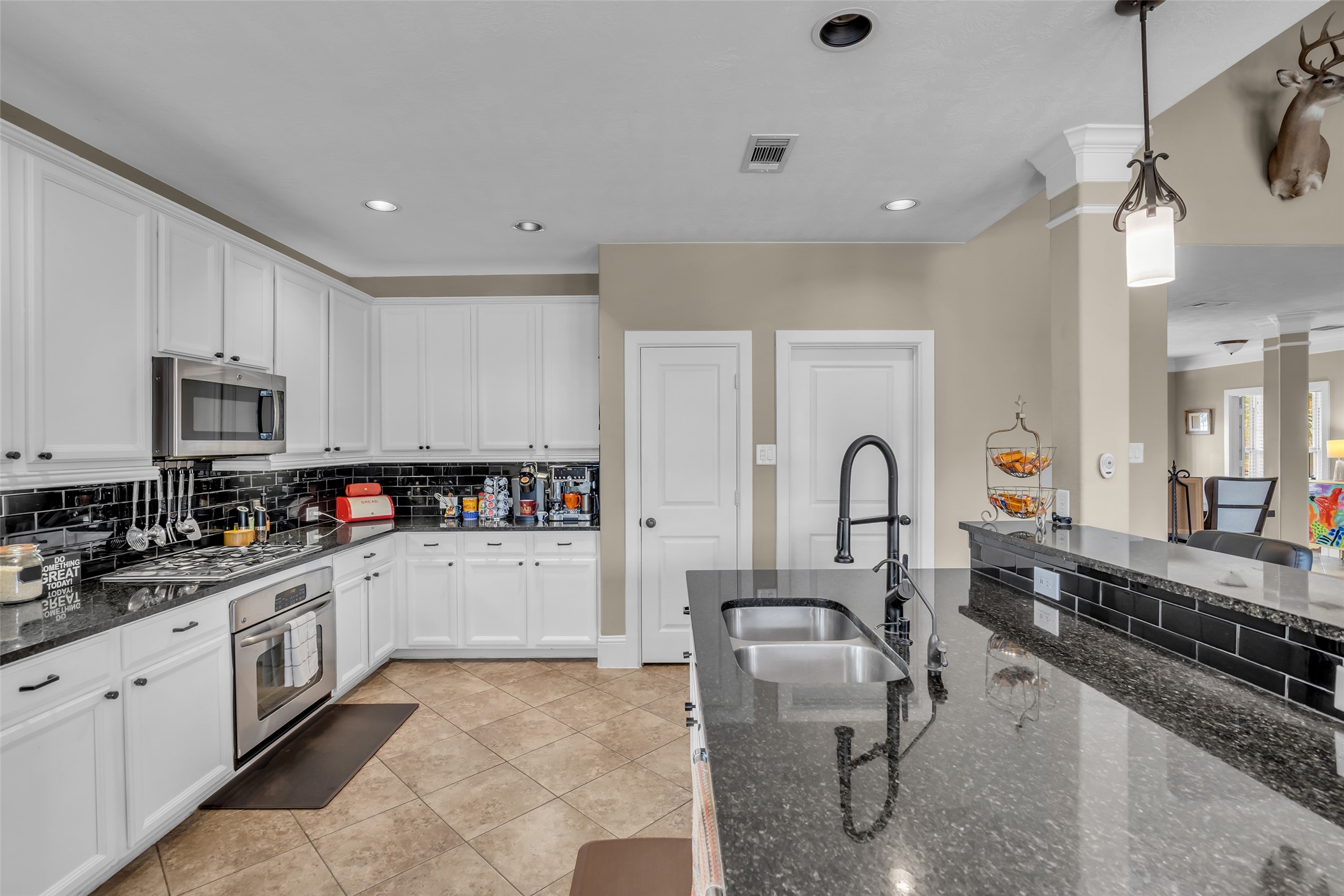 12602 Spellbrook Point Lane Tomball, TX 77377 - Photo 28 of 47 a kitchen with cabinets a sink and appliances