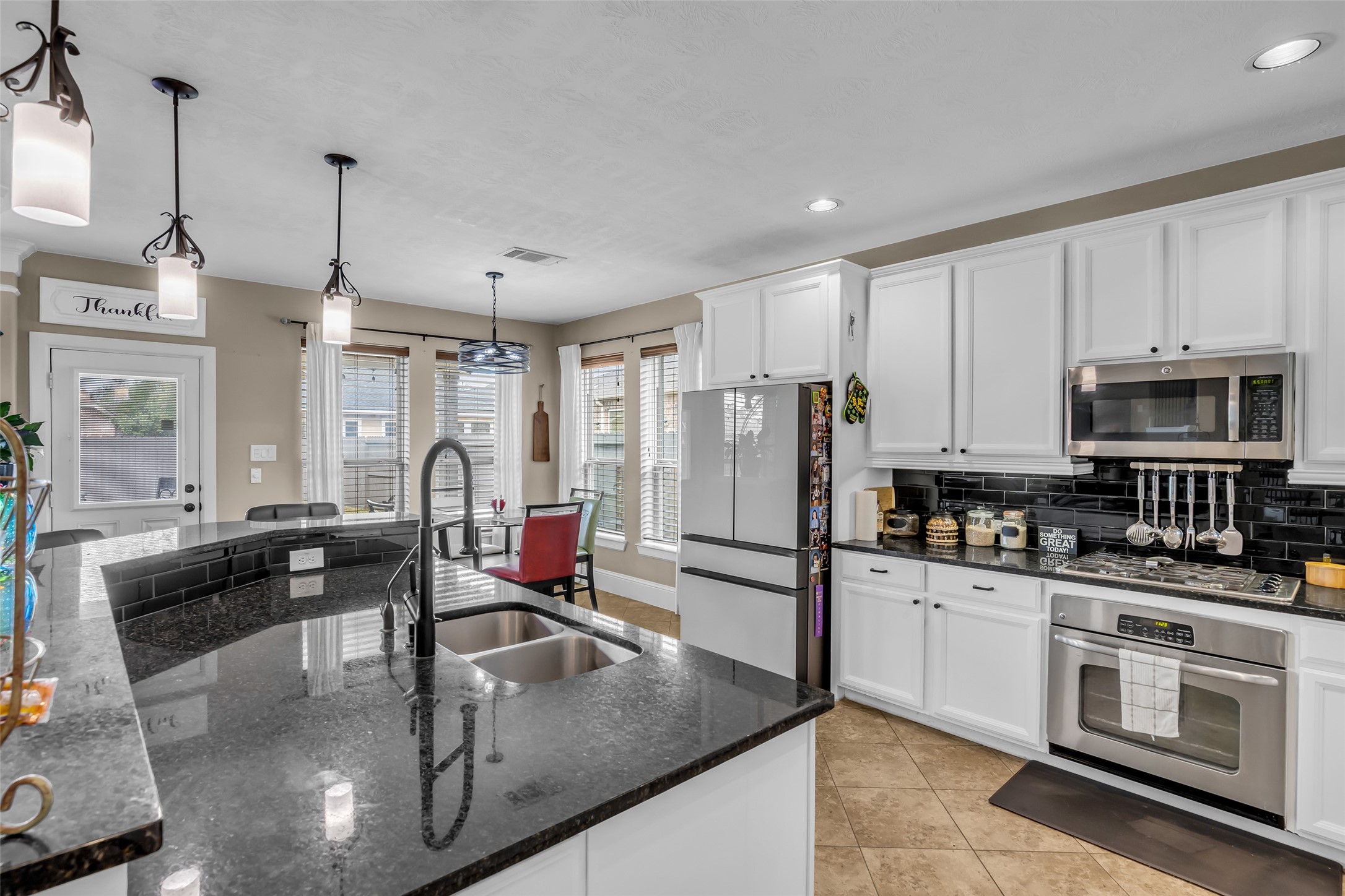 12602 Spellbrook Point Lane Tomball, TX 77377 - Photo 30 of 47 a kitchen with stainless steel appliances granite countertop a sink a stove and a refrigerator