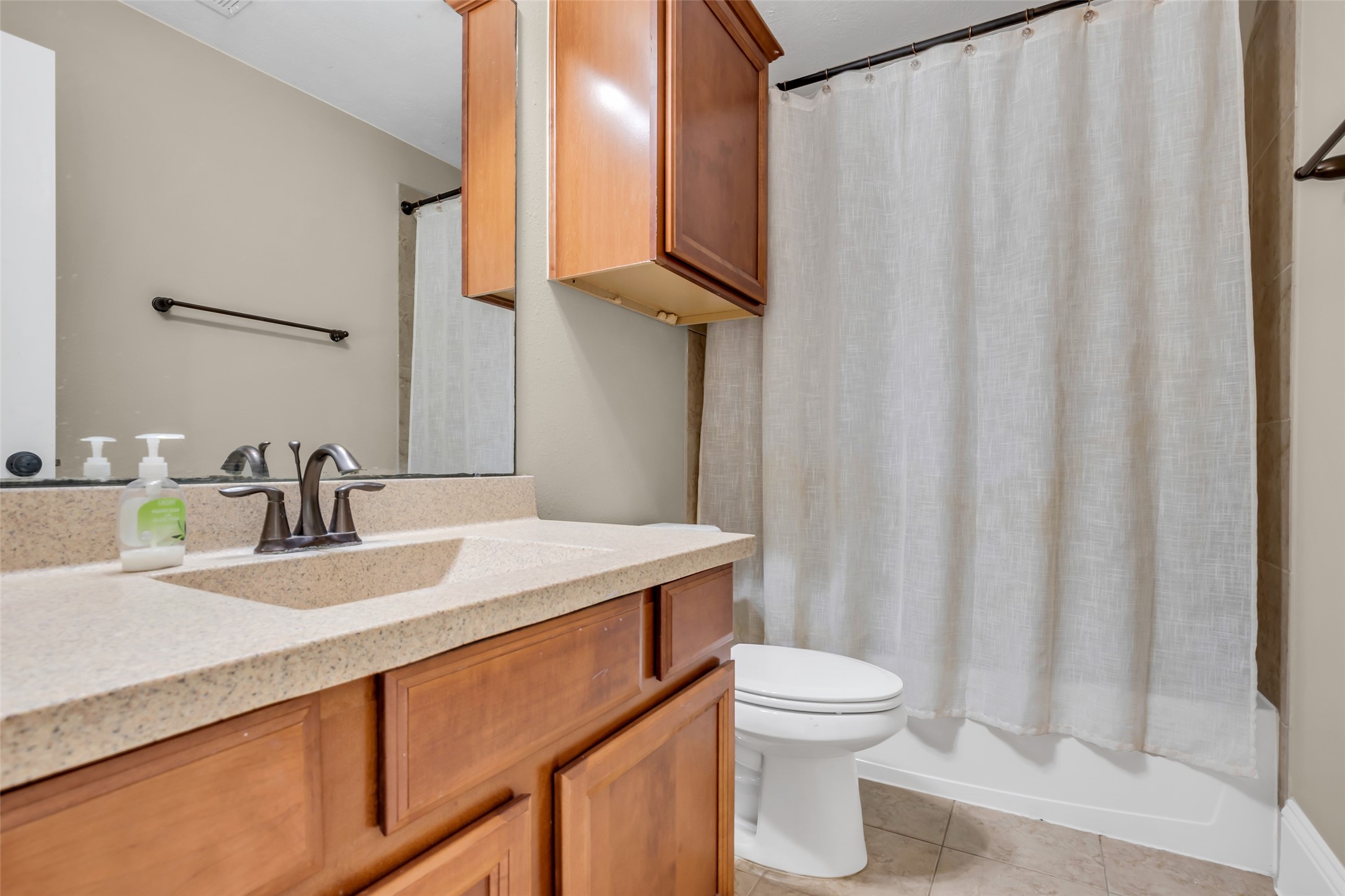 12602 Spellbrook Point Lane Tomball, TX 77377 - Photo 42 of 47 a bathroom with a sink a toilet and shower curtain