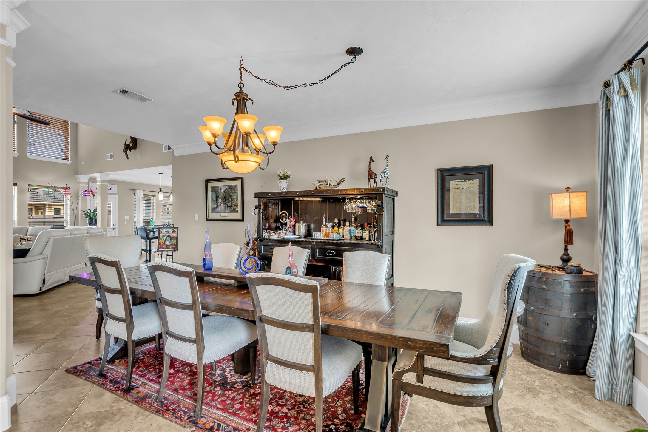 12602 Spellbrook Point Lane Tomball, TX 77377 - Photo 45 of 47 a dining room with wooden floor a chandelier a wooden table and chairs