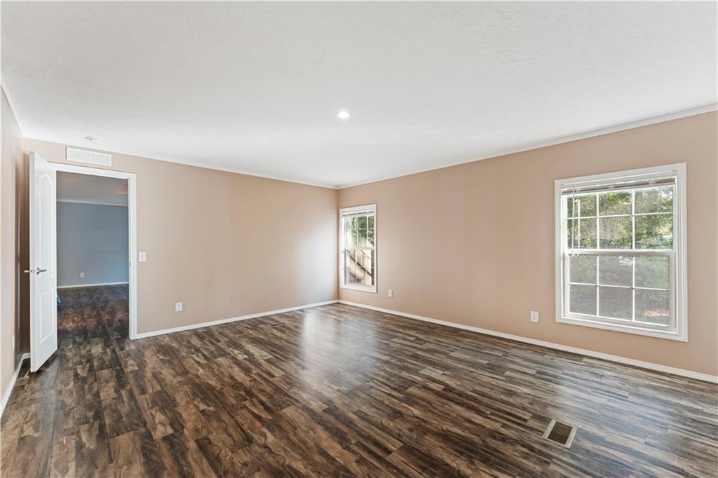 89 Ridge Road Seale, AL 36875 - Photo 22 of 46 Spacious room featuring wood-finish flooring, two windows, recessed lighting, and neutral wall tones