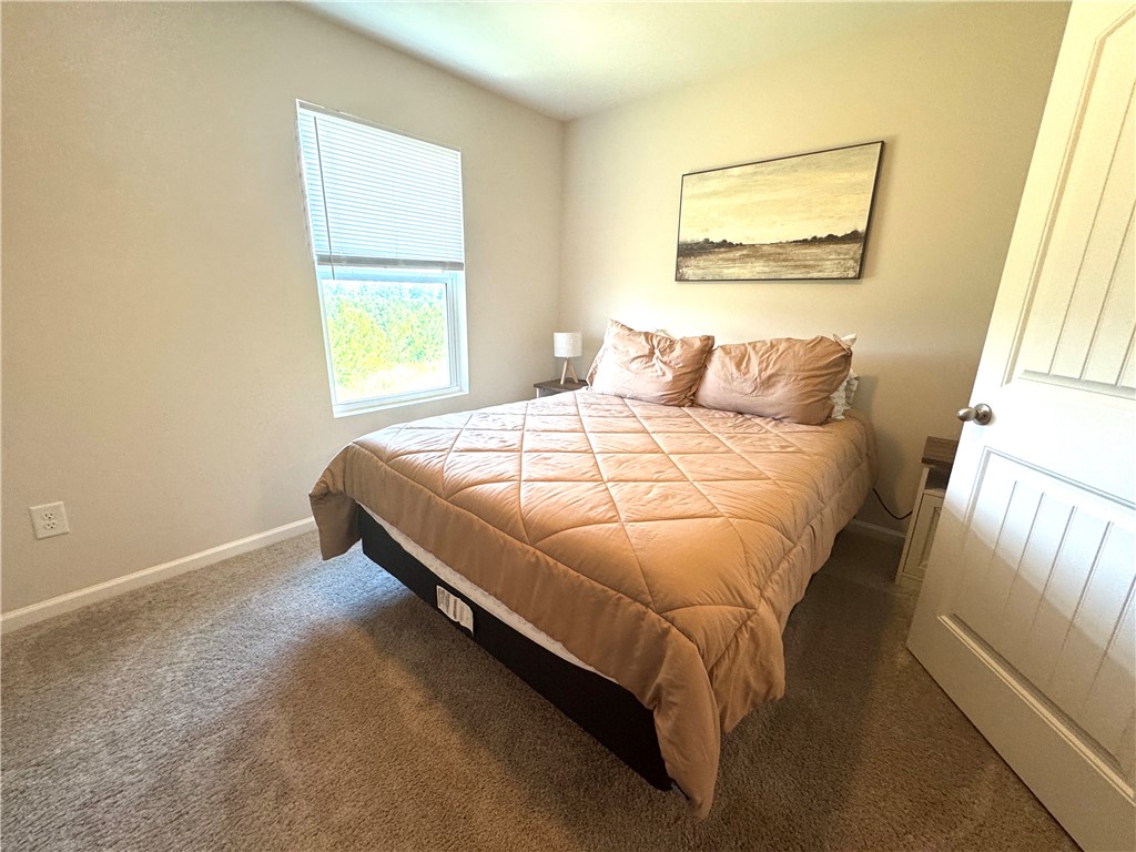 143 Adger Road Pendleton, SC 29670 - Photo 24 of 30 Plush carpeting and a large window create a comfortable, inviting atmosphere in this bedroom.