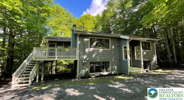 a view of an house with backyard space and balcony