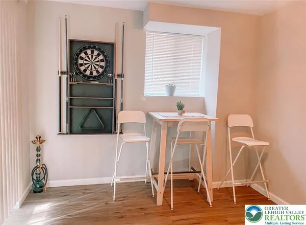 a dining room with a wooden table and chairs