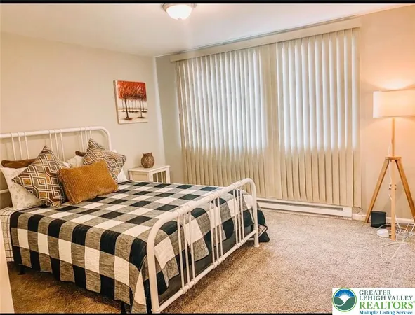 a bedroom with a bed and a painting on the wall