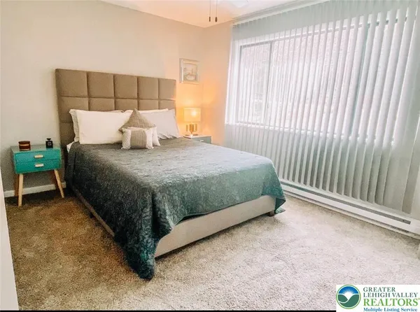 a bed sitting in a bedroom next to a window