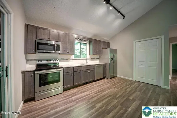 a kitchen with a sink cabinets and stainless steel appliances