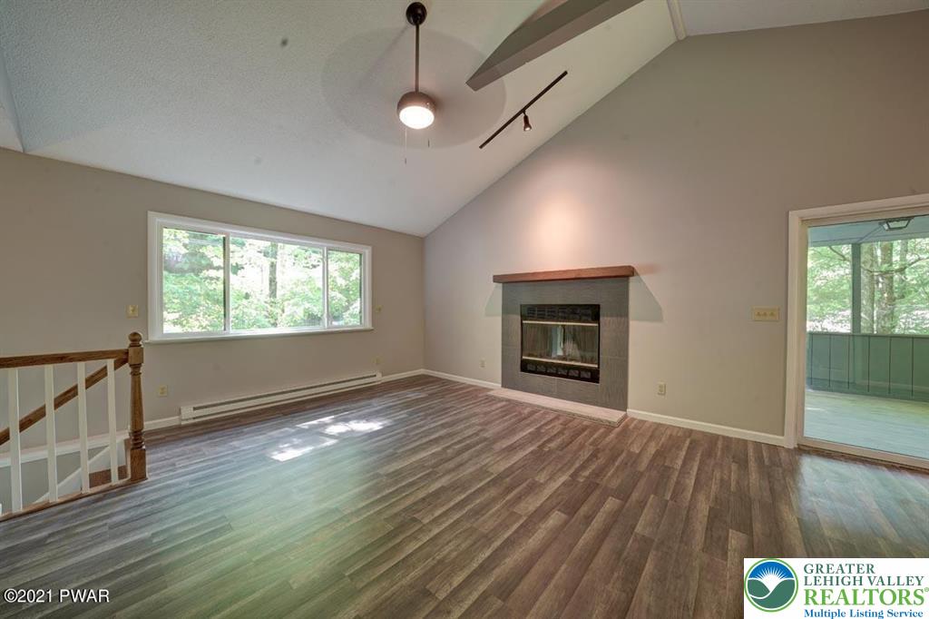 199 North Northgate Road Lake Ariel, PA 18436 - Photo 7 of 35 an empty room with wooden floor fireplace and windows