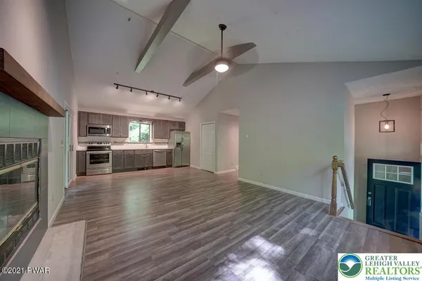 a view of kitchen living room with wooden floor