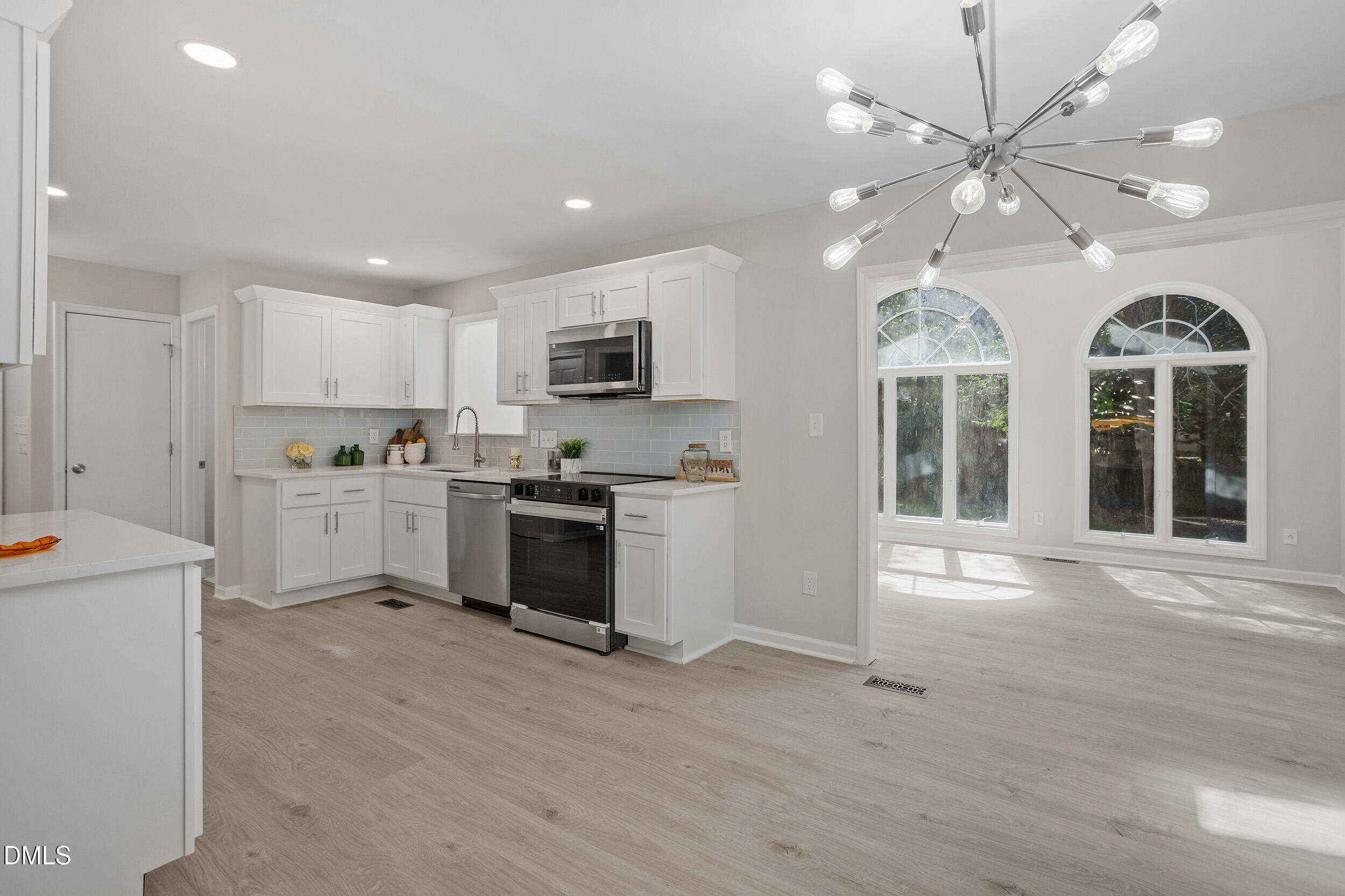 1103 Suterland Road Cary, NC 27511 - Photo 11 of 21 a kitchen with stove a sink and a refrigerator