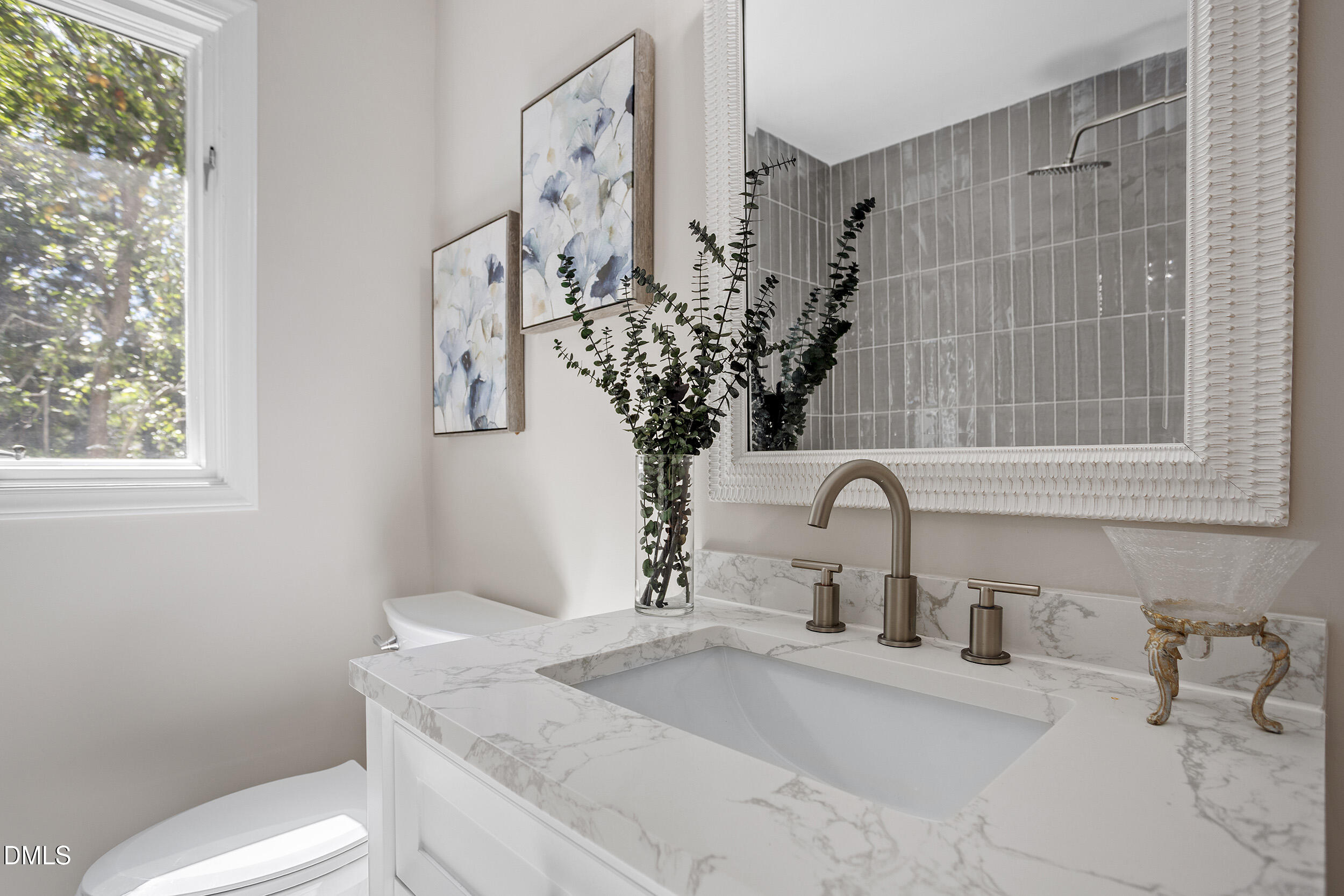 1103 Suterland Road Cary, NC 27511 - Photo 19 of 21 a bathroom with a granite countertop sink a toilet and with mirror