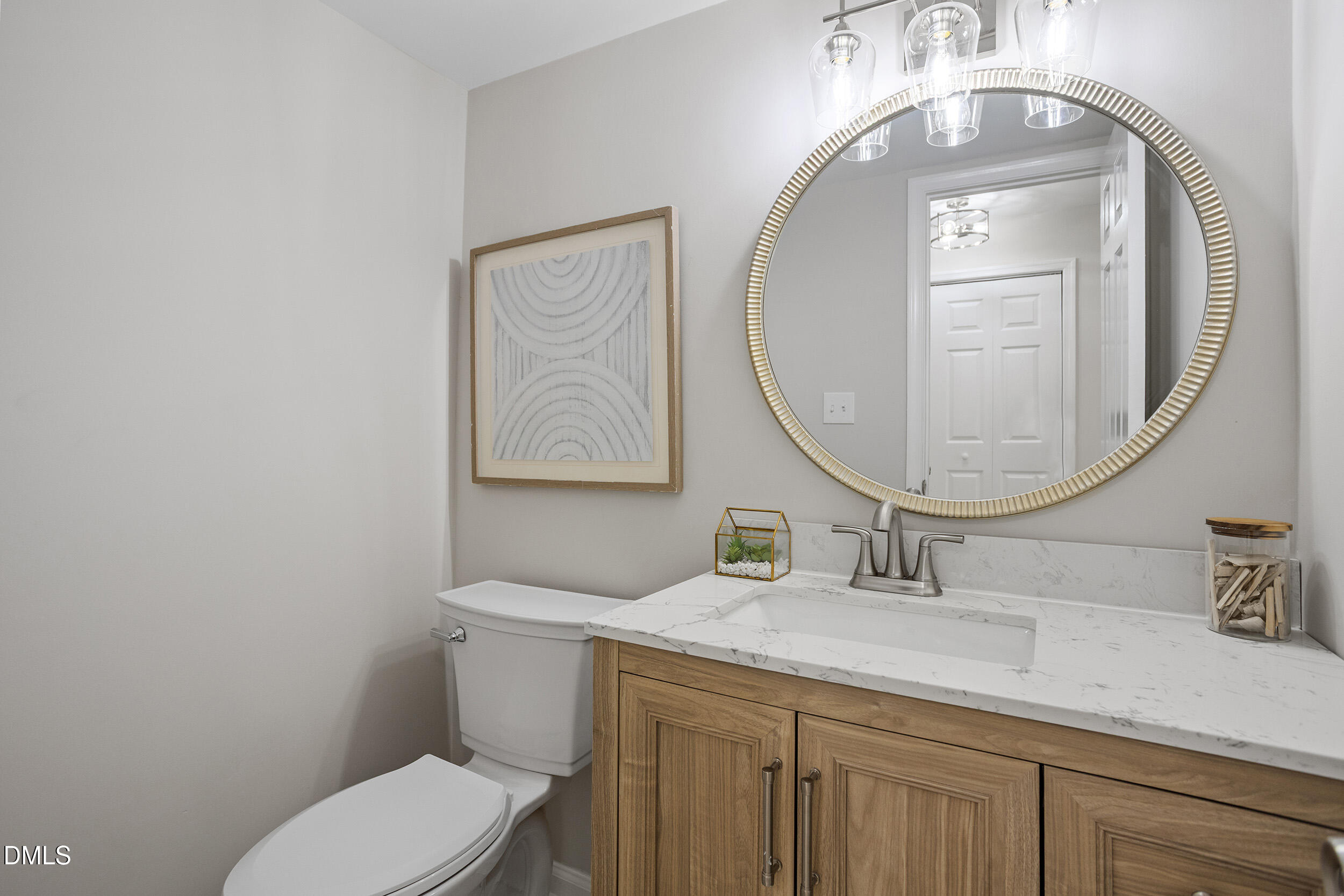 1103 Suterland Road Cary, NC 27511 - Photo 20 of 21 a bathroom with a toilet a sink and a mirror