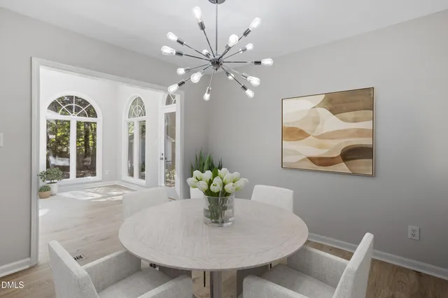 a view of a dining room with furniture and chandelier