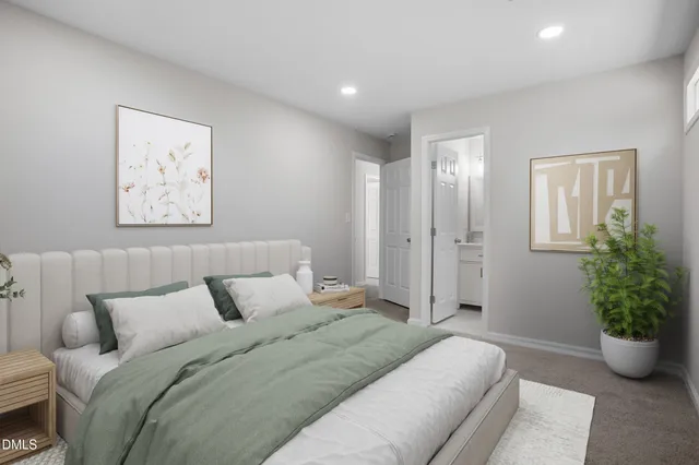 a spacious bedroom with a bed and a potted plant