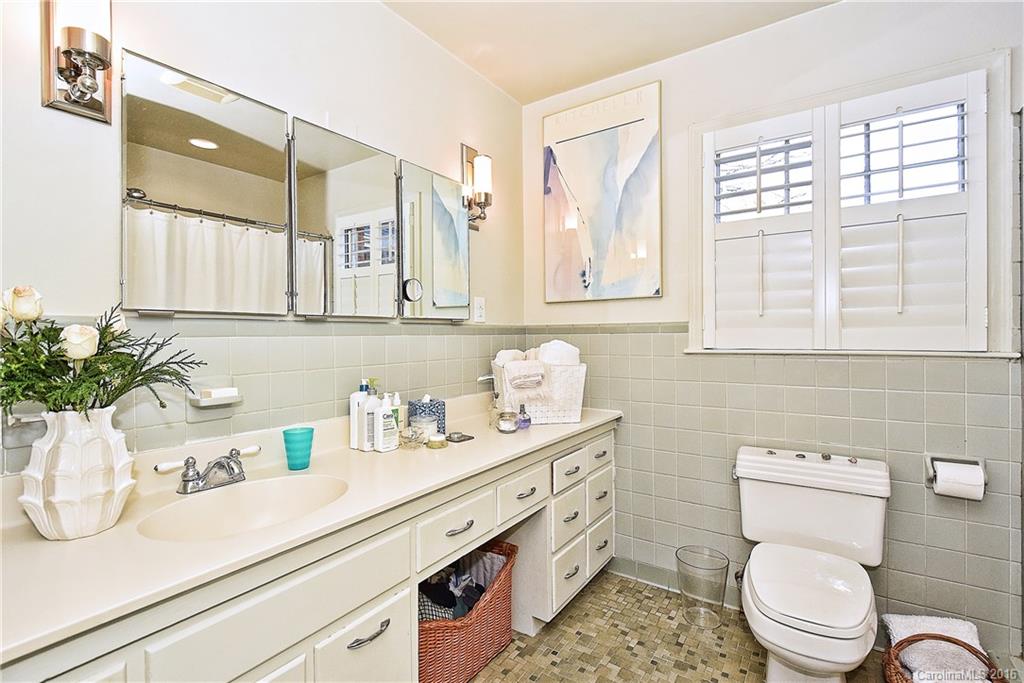 2410 Ferncliff Road Charlotte, NC 28211 - Photo 14 of 24 a bathroom with a granite countertop toilet sink and mirror