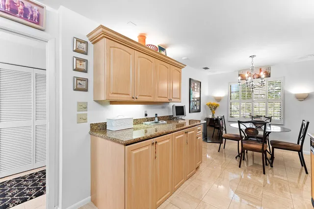 a kitchen with stainless steel appliances granite countertop a refrigerator sink and cabinets