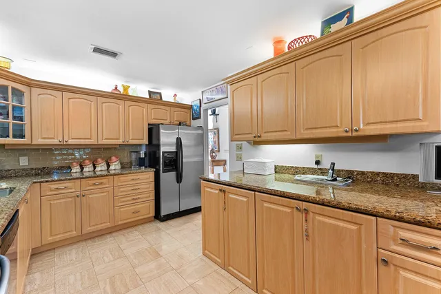 a spacious bedroom with a bed and a flat screen tv