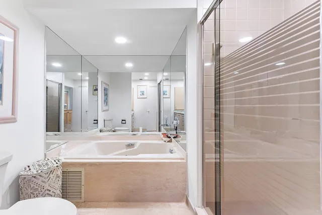 a bathroom with a sink vanity mirror and toilet