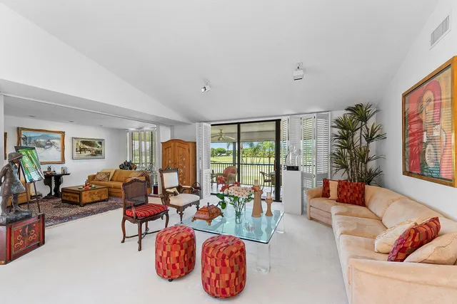 a living room with furniture and a floor to ceiling window