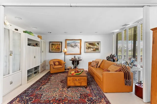 a large kitchen with stainless steel appliances granite countertop a stove top oven a sink dishwasher and a refrigerator