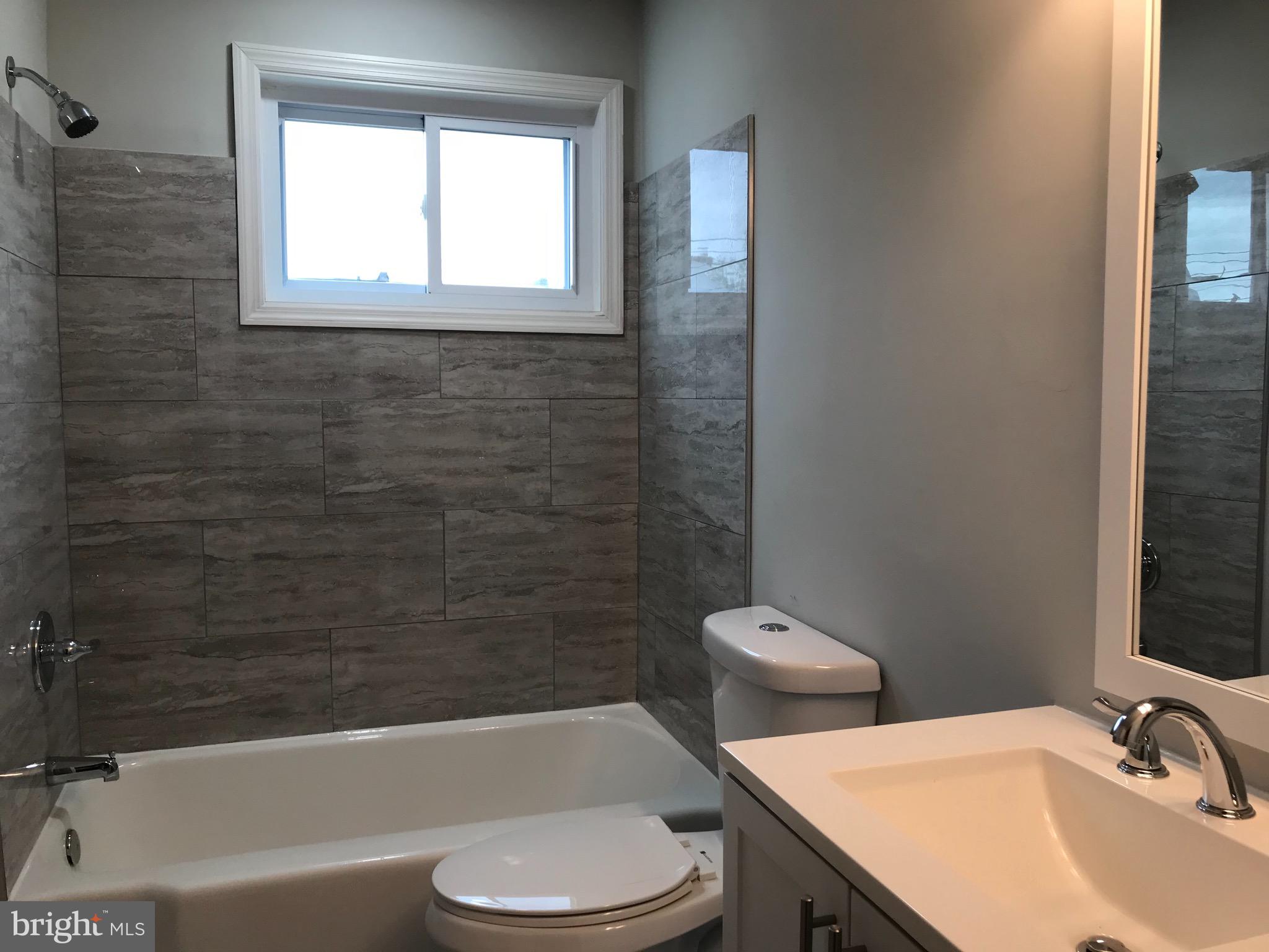 7810 Rockbourne Road Baltimore, MD 21222 - Photo 31 of 59 Tiled surround in bathroom