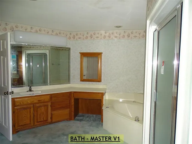 a bathroom with a sink a mirror and a bathtub