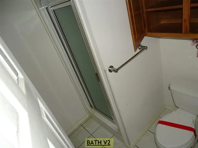 a bathroom with a toilet and a shower