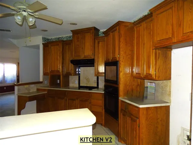 a kitchen with stainless steel appliances a sink and a refrigerator