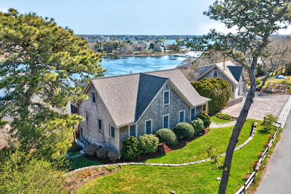 a view of a house with a yard and pathway