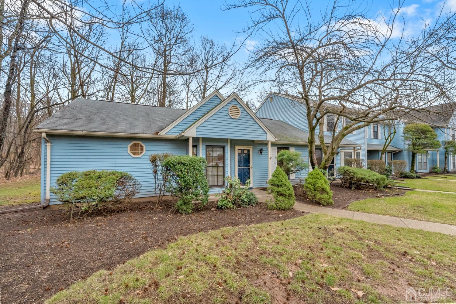 1801 Timber Oaks Road Edison, NJ 08820 - Photo 3 of 35 a front view of a house with garden