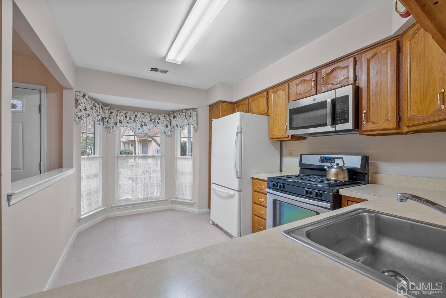 1801 Timber Oaks Road Edison, NJ 08820 - Photo 6 of 35 a kitchen with stainless steel appliances granite countertop a refrigerator a stove top oven a sink and dishwasher