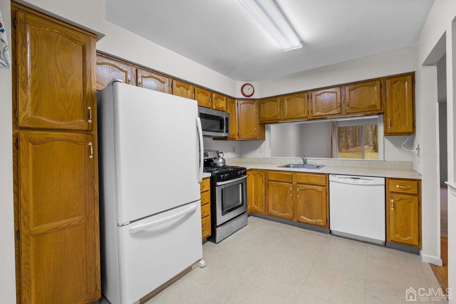 1801 Timber Oaks Road Edison, NJ 08820 - Photo 7 of 35 a white refrigerator freezer and a stove sitting inside of a kitchen