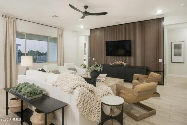 a bedroom with furniture and a large window