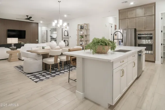 a large kitchen with a table and chairs